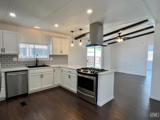 kitchen featuring visible vents, island range hood, a sink, a peninsula, and appliances with stainless steel finishes