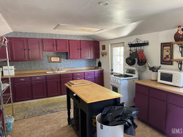 1 Jasper Ave, Rosamond, CA 93561 - kitchen featuring white appliances, vaulted ceiling, and dark brown cabinets