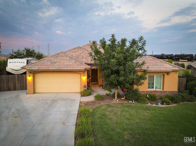 ranch-style home featuring a yard and a garage