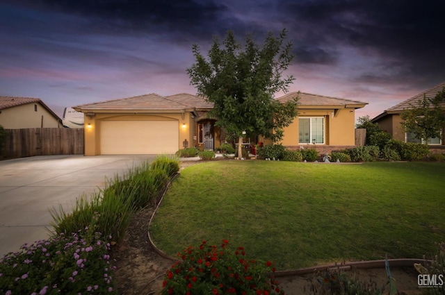 view of front facade featuring a garage and a lawn