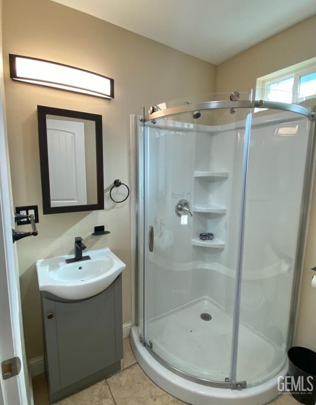 706 A St, Bakersfield, CA 93304 - bathroom with a stall shower, vanity, and tile patterned floors