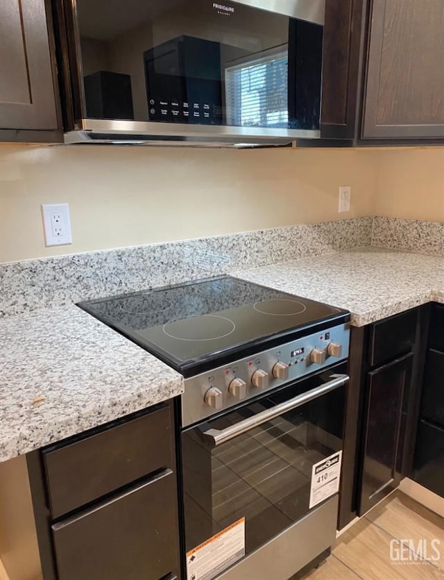 706 A St, Bakersfield, CA 93304 - kitchen with appliances with stainless steel finishes, dark brown cabinets, and light countertops
