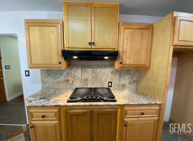 706 A St, Bakersfield, CA 93304 - kitchen with under cabinet range hood, tasteful backsplash, black gas stovetop, and light brown cabinetry