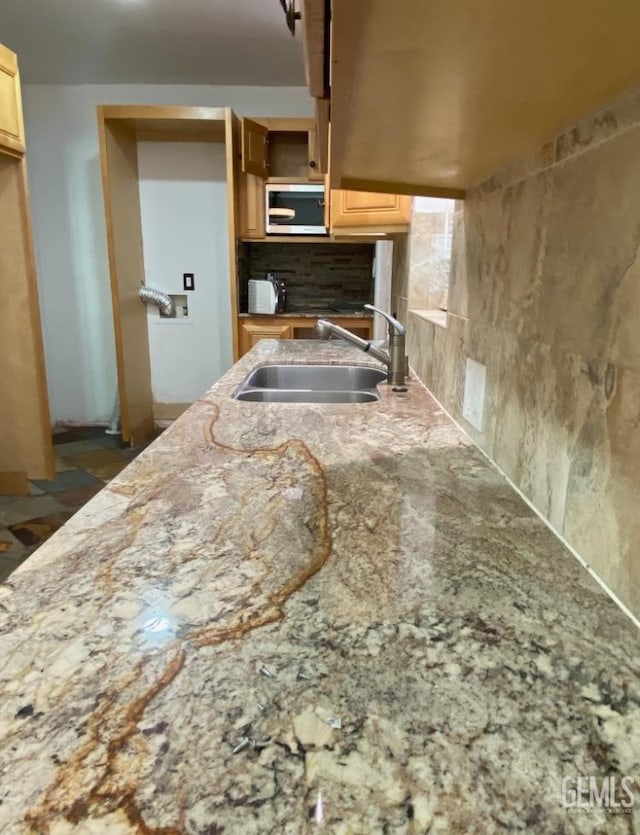 706 A St, Bakersfield, CA 93304 - kitchen with a sink, light brown cabinetry, stainless steel microwave, backsplash, and light stone counters