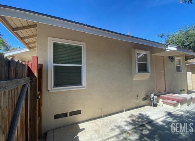706 A St, Bakersfield, CA 93304 - rear view of house with stucco siding and a patio