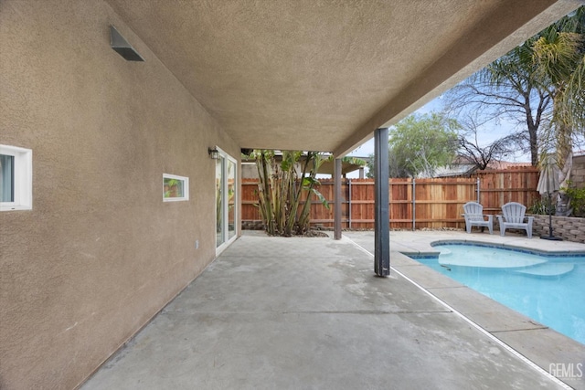 view of swimming pool featuring a fenced in pool, a patio area, and fence