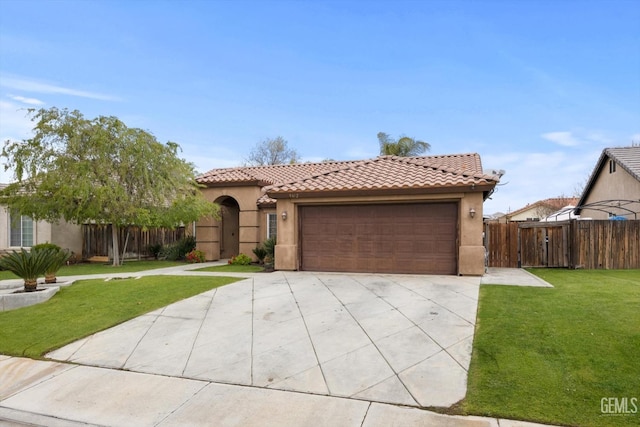 mediterranean / spanish-style home featuring a tiled roof, a front lawn, fence, and stucco siding