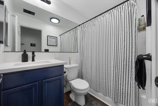 bathroom featuring visible vents, shower / bathtub combination with curtain, toilet, vanity, and wood finished floors