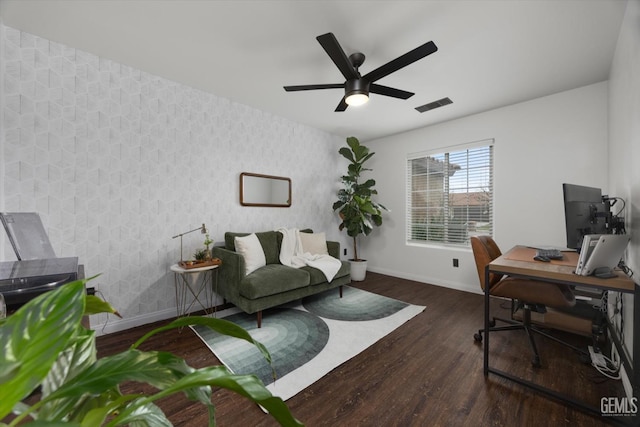 home office featuring wood finished floors, visible vents, baseboards, and wallpapered walls