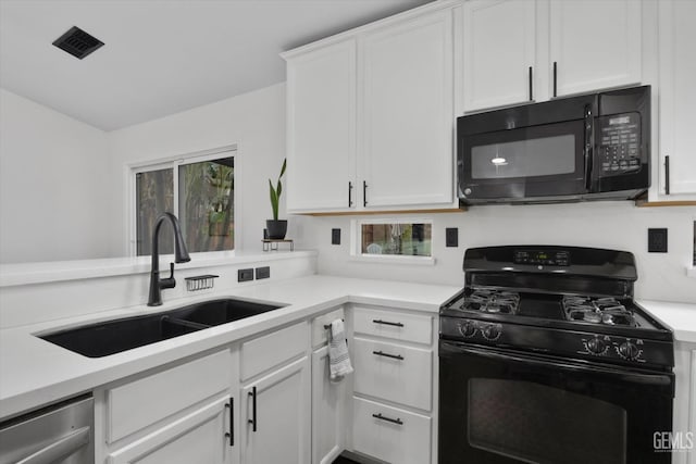 kitchen with a sink, visible vents, white cabinets, light countertops, and black appliances