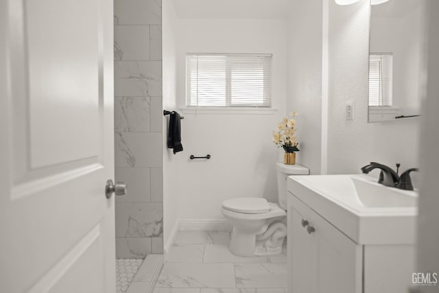 925 Yale Ave, Bakersfield, CA 93305 - bathroom with marble look tile flooring, toilet, vanity, a shower, and baseboards