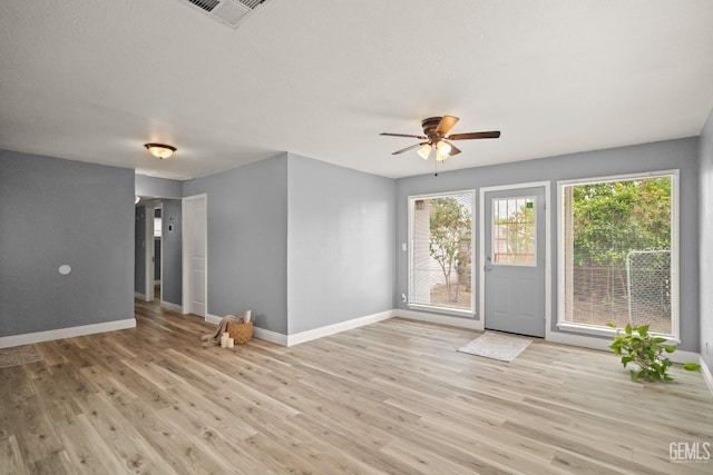 925 Yale Ave, Bakersfield, CA 93305 - unfurnished living room featuring baseboards, ceiling fan, and light wood-style flooring