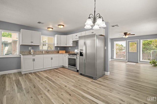 925 Yale Ave, Bakersfield, CA 93305 - kitchen featuring stainless steel appliances, baseboards, light wood finished floors, white cabinetry, and plenty of natural light
