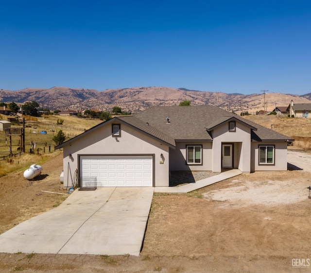 view of front facade with a mountain view and a garage