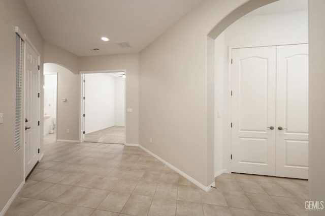 14010 Park Palisades Dr, Bakersfield, CA 93306 - corridor featuring arched walkways, light tile patterned floors, recessed lighting, and baseboards