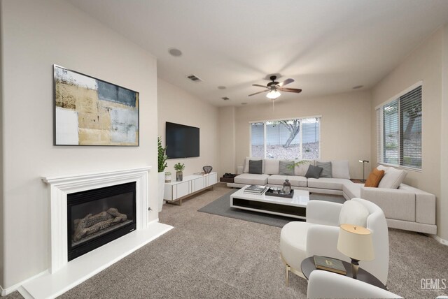 14010 Park Palisades Dr, Bakersfield, CA 93306 - carpeted living room featuring a ceiling fan, a glass covered fireplace, and baseboards