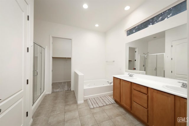 14010 Park Palisades Dr, Bakersfield, CA 93306 - bathroom featuring a stall shower, tile patterned flooring, a bath, double vanity, and recessed lighting