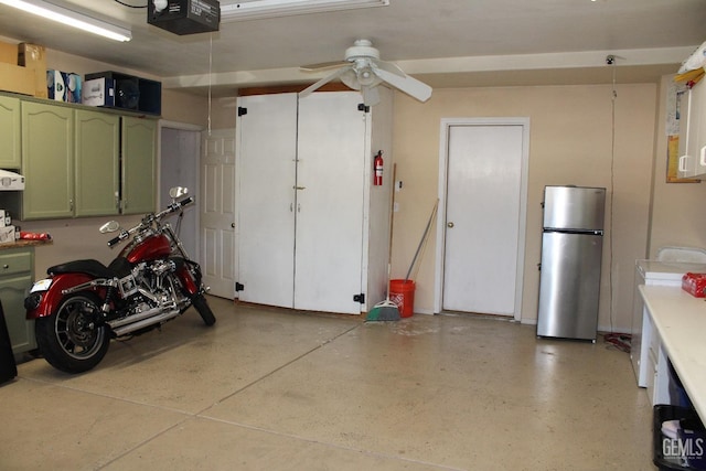 garage featuring a garage door opener, stainless steel refrigerator, and ceiling fan