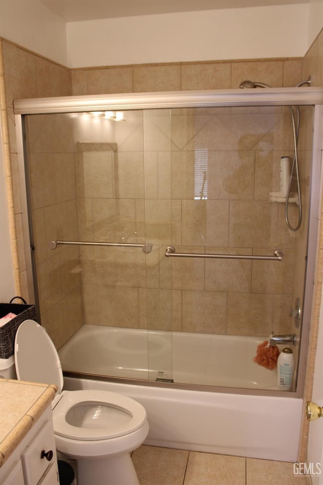 full bathroom featuring tile patterned flooring, vanity, toilet, and combined bath / shower with glass door