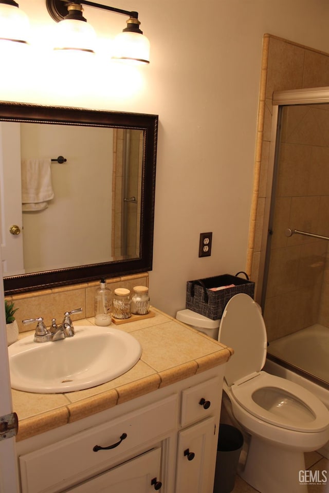 full bathroom featuring toilet, vanity, and combined bath / shower with glass door