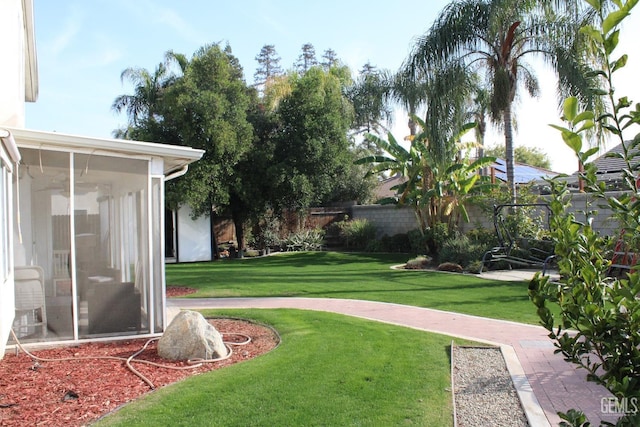 view of yard with a sunroom