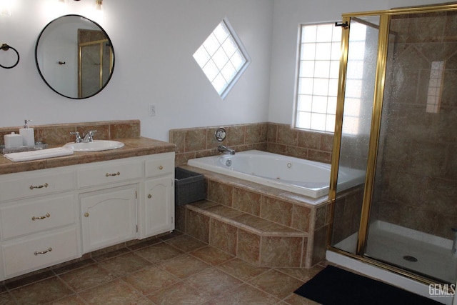 bathroom featuring tile patterned flooring, vanity, shower with separate bathtub, and a wealth of natural light