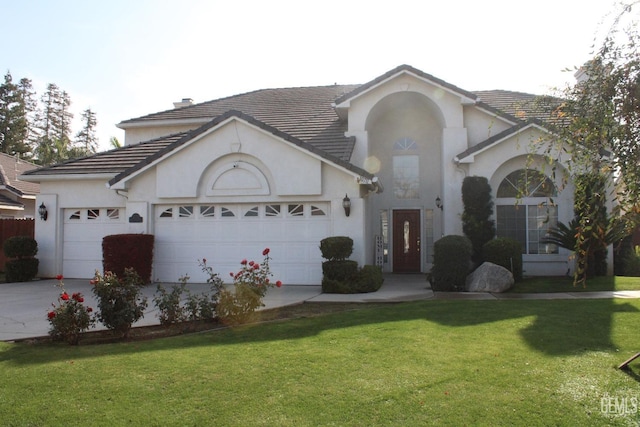 view of front of house featuring a front yard and a garage