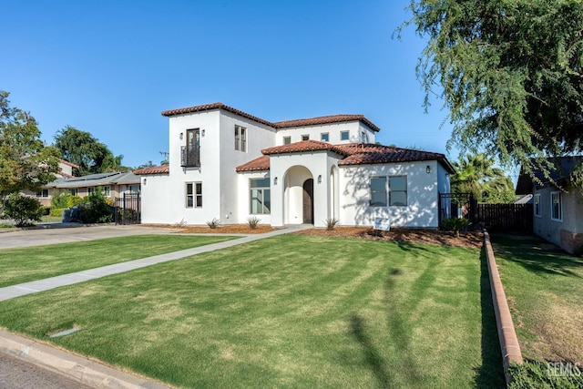 mediterranean / spanish-style house with a front lawn