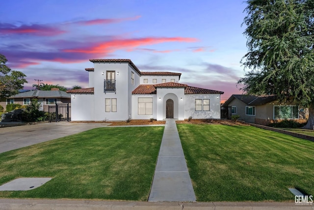 mediterranean / spanish-style house with a yard