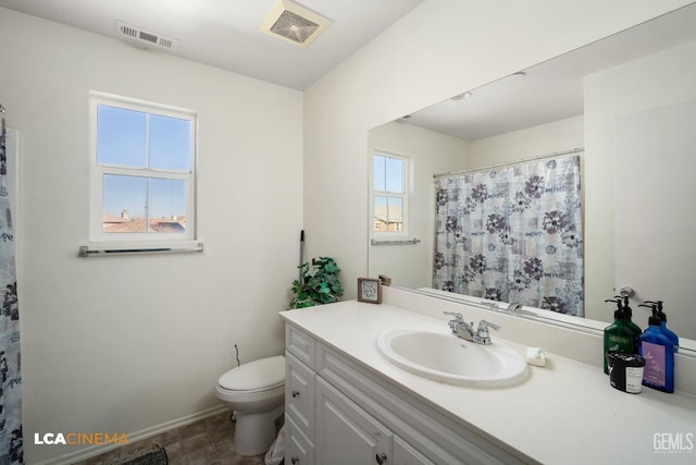 bathroom with vanity, toilet, and curtained shower