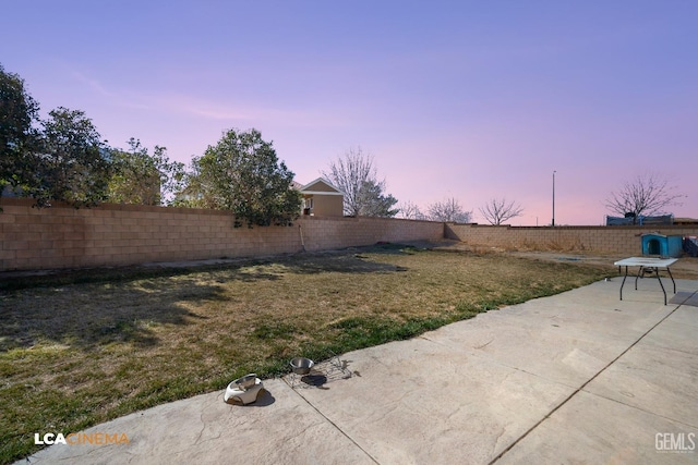 yard at dusk with a patio area