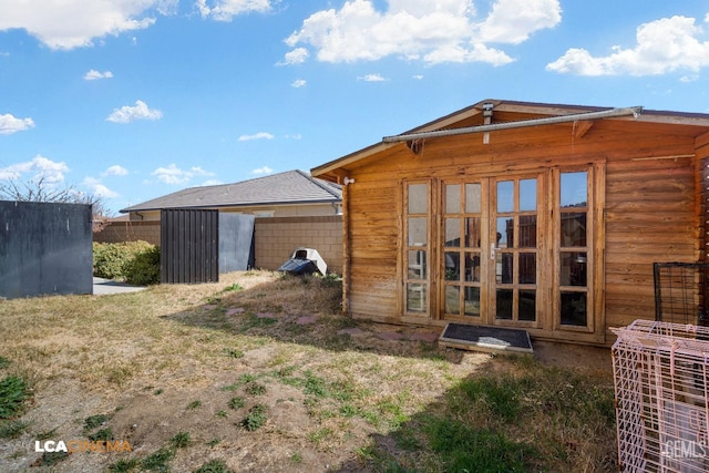 back of property with an outdoor structure