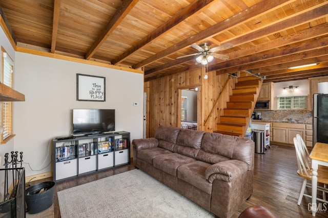 45985 Ridge Rd, Posey, CA 93260 - living area featuring beam ceiling, stairway, a healthy amount of sunlight, and dark wood-style flooring