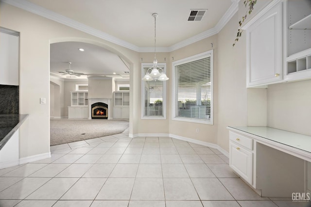 1904 Wedgemont Pl, Bakersfield, CA 93311 - unfurnished dining area with crown molding, ceiling fan, light tile patterned flooring, baseboards, and a warm lit fireplace