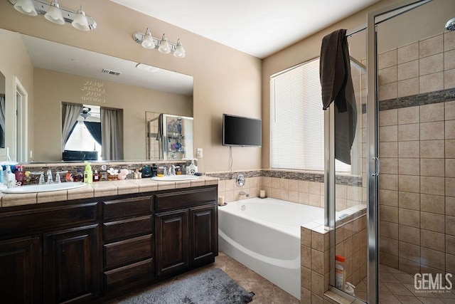 bathroom featuring tile patterned floors, vanity, and separate shower and tub