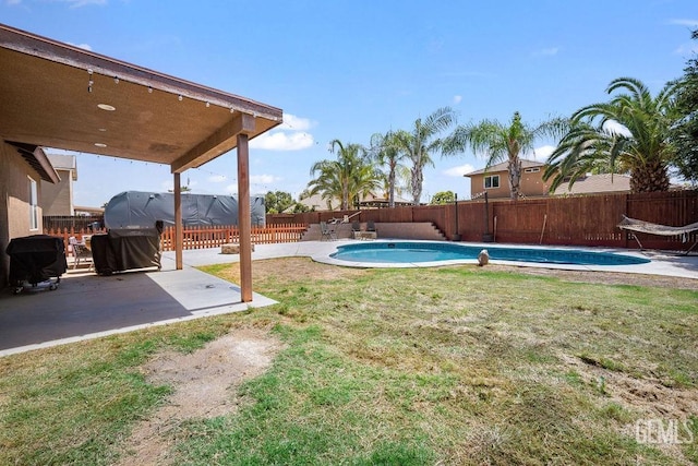 view of yard with a fenced in pool and a patio