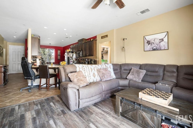 living room with ceiling fan and dark hardwood / wood-style floors