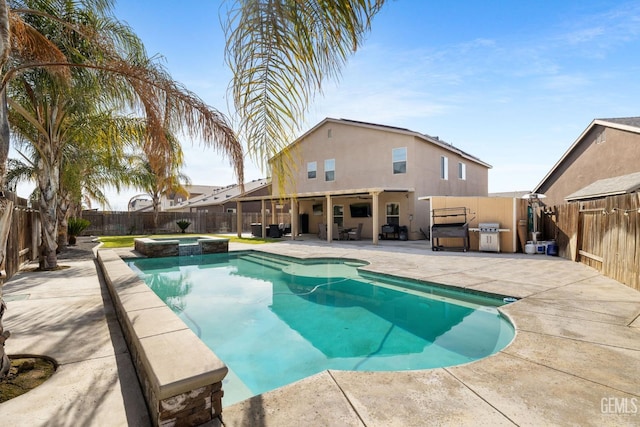 view of swimming pool with area for grilling, a patio, and an in ground hot tub