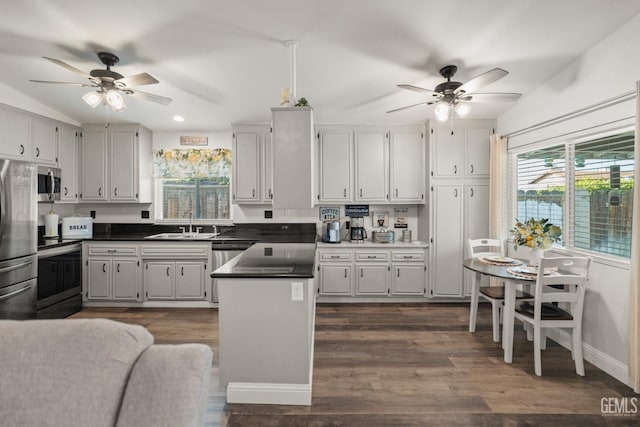 404 Mckinley St, Taft, CA 93268 - kitchen with ceiling fan, stainless steel appliances, dark wood-type flooring, dark countertops, and recessed lighting