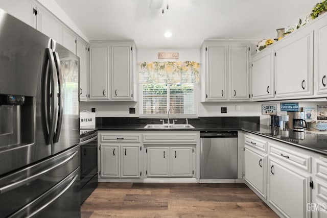 404 Mckinley St, Taft, CA 93268 - kitchen featuring appliances with stainless steel finishes, dark countertops, white cabinets, and recessed lighting