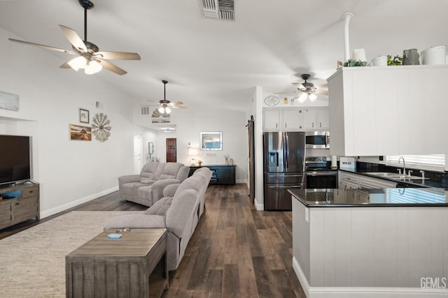 404 Mckinley St, Taft, CA 93268 - kitchen with appliances with stainless steel finishes, dark countertops, ceiling fan, dark wood-style floors, and vaulted ceiling