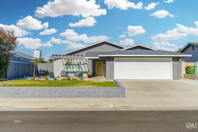 404 Mckinley St, Taft, CA 93268 - single story home featuring an attached garage, concrete driveway, a pergola, and a front lawn