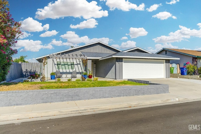 404 Mckinley St, Taft, CA 93268 - view of front of property featuring a garage, driveway, stucco siding, and a pergola