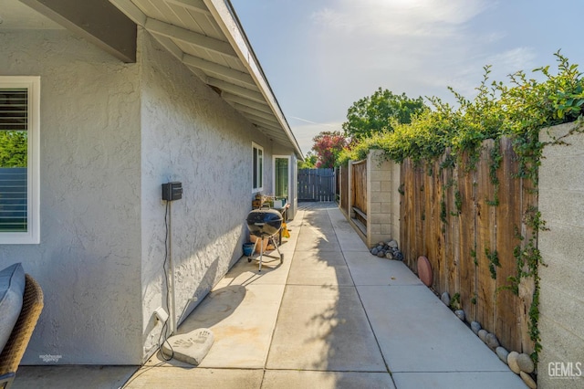 404 Mckinley St, Taft, CA 93268 - view of side of home featuring stucco siding and a patio