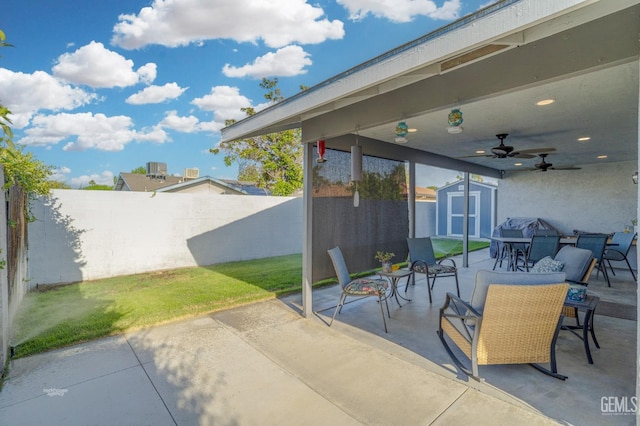 404 Mckinley St, Taft, CA 93268 - fenced backyard with a shed, a patio, outdoor dining area, a ceiling fan, and grilling area