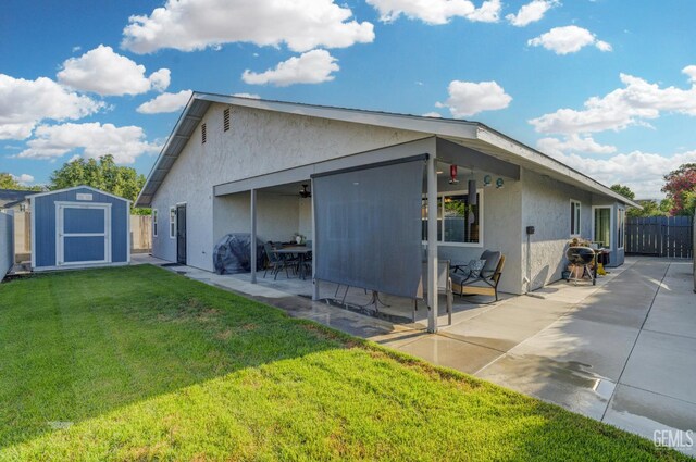 404 Mckinley St, Taft, CA 93268 - rear view of house featuring a storage shed, a patio, and stucco siding