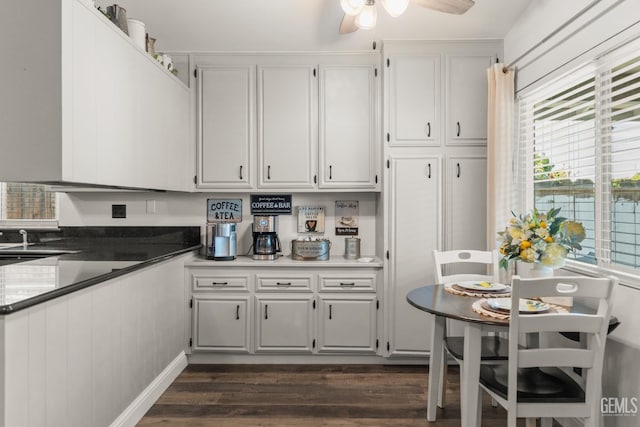 404 Mckinley St, Taft, CA 93268 - kitchen with dark wood-type flooring, white cabinetry, and ceiling fan