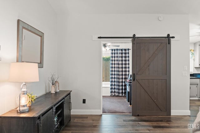 404 Mckinley St, Taft, CA 93268 - foyer entrance with dark wood finished floors, a barn door, and a ceiling fan