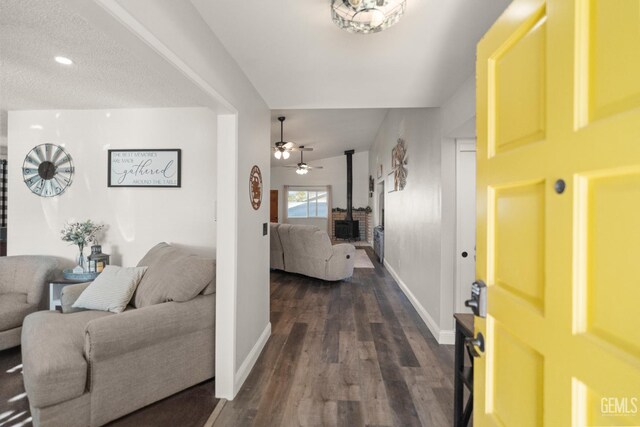 404 Mckinley St, Taft, CA 93268 - foyer with dark wood-style flooring, ceiling fan, a wood stove, and recessed lighting