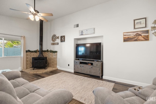 404 Mckinley St, Taft, CA 93268 - living room with a wood stove, wood finished floors, a ceiling fan, and high vaulted ceiling